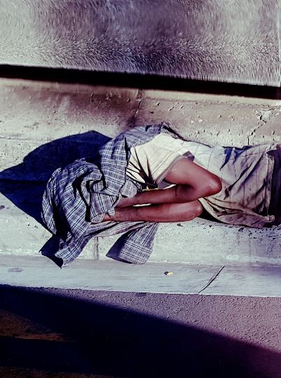 Homeless person asleep on the street in Cape Town